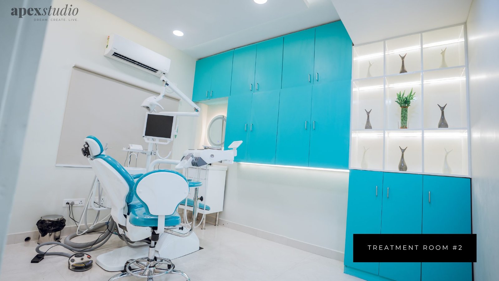 Treatment room two with turquoise cabinetry and display shelving
