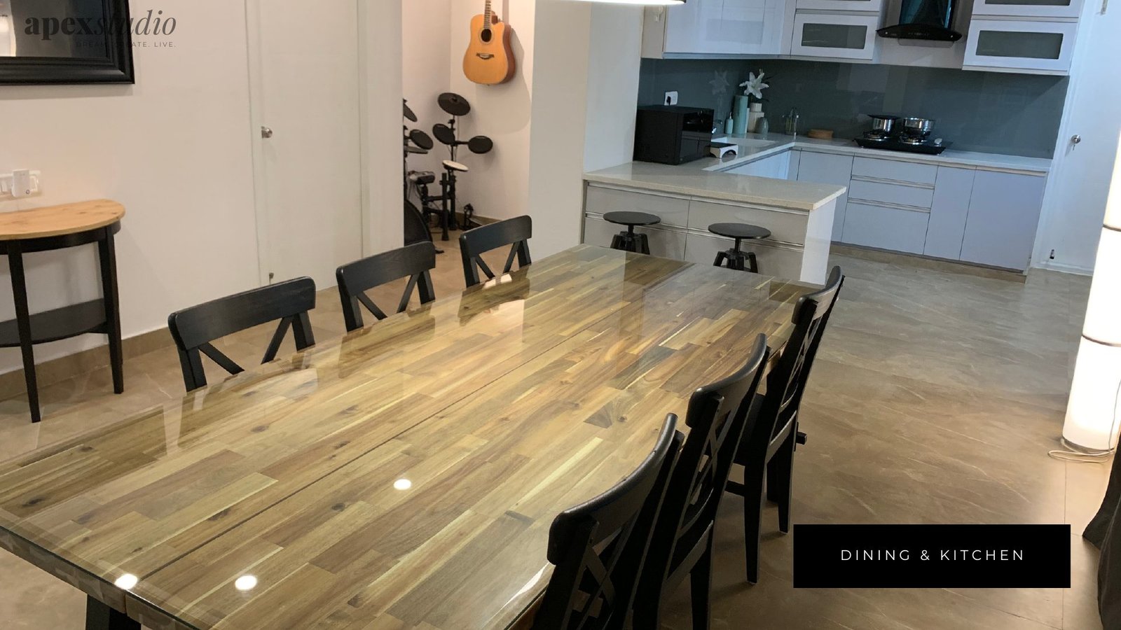 Dining table with open kitchen and drum kit beyond